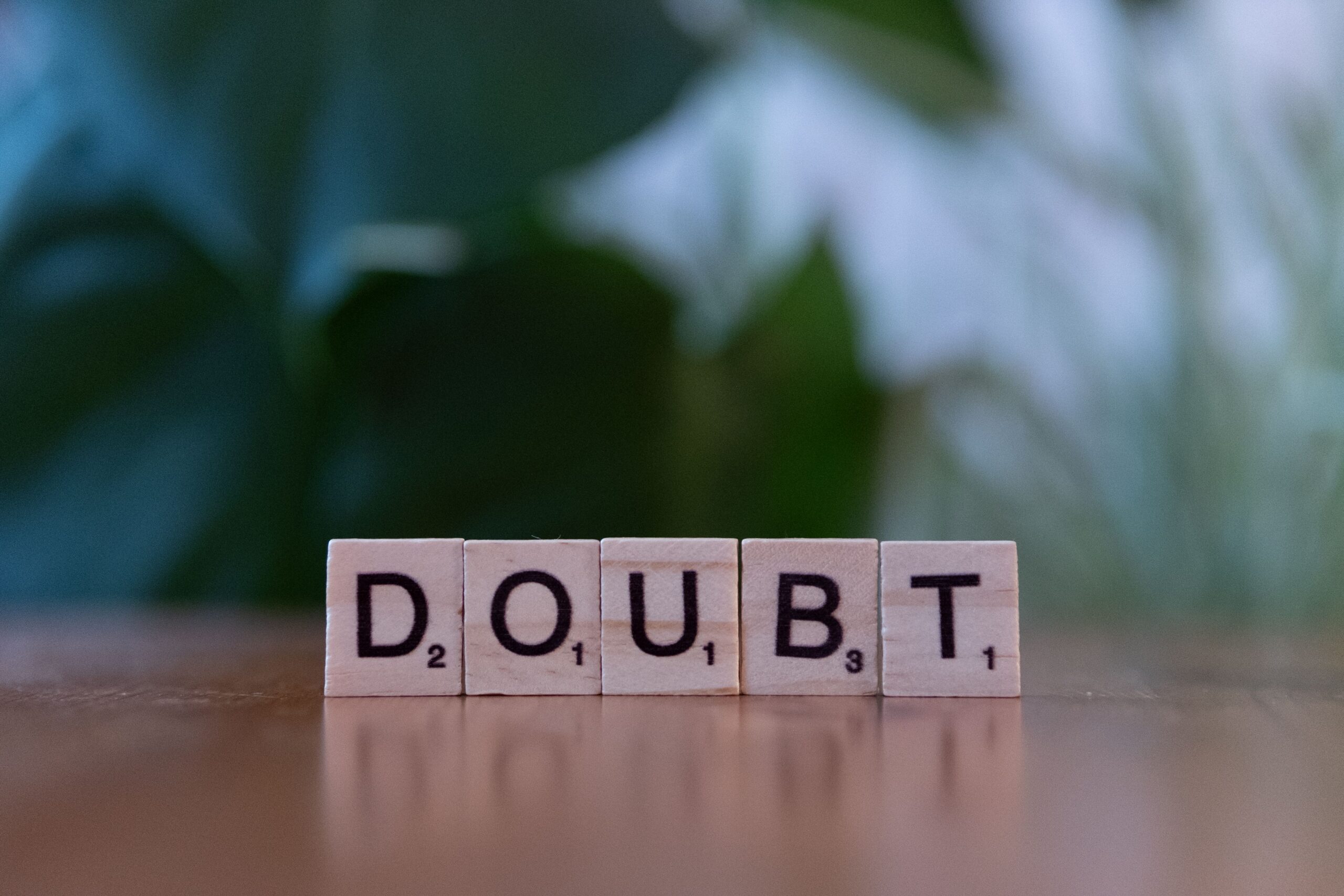 Scrabble letter tiles spelling the word doubt, representing anxiety or OCD