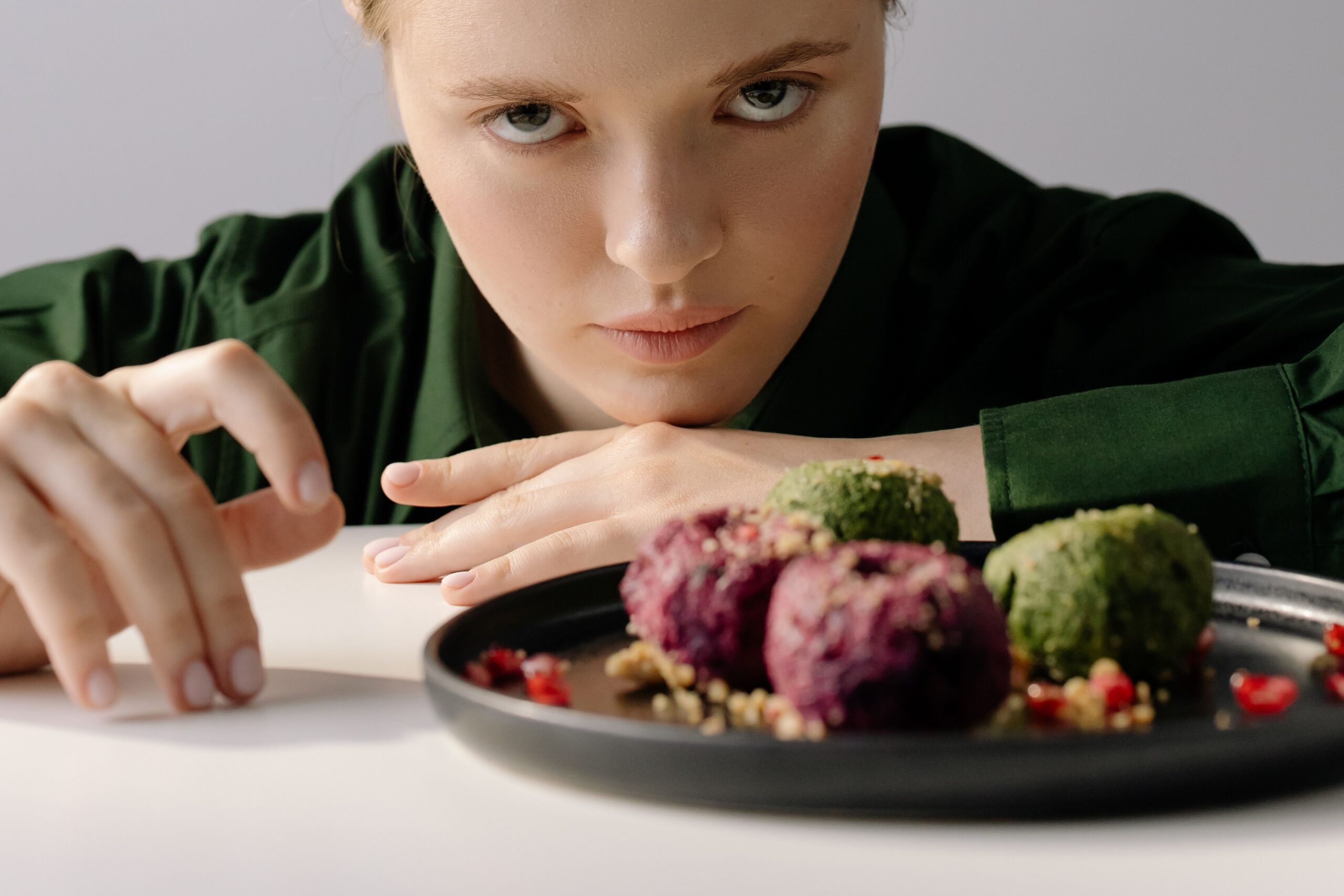 Woman managing emetophobia treatment Ontario, sitting calmly beside a plate of food